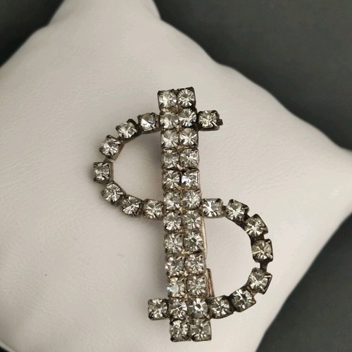 Dollar brooch like new with stones