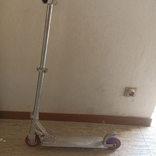 Silver metal scooter used, lightweight and foldable