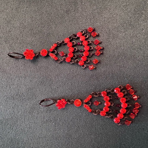 Vintage metal earrings used with red-orange crystals