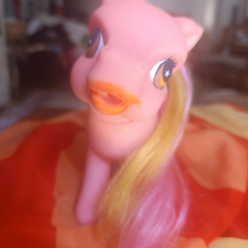 Large pink pony toy with colorful mane and tail
