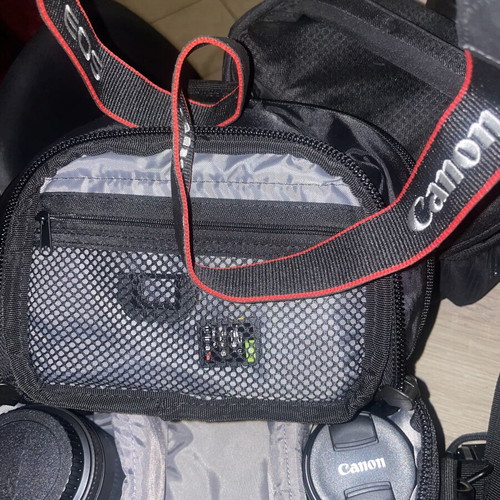 Canon EOS 1200D camera kit with lenses, memory card, battery, charger, and carrying bag
