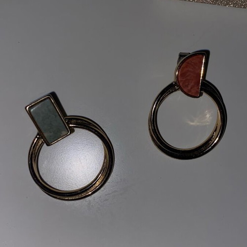 Gold hoop earrings used with detail on top part