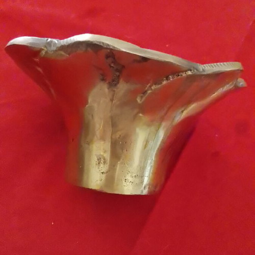 Carved brass decorative item, useful as ashtray or candle holder