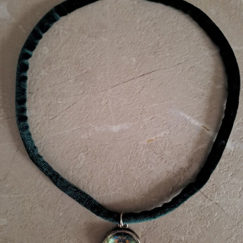 Pendant with stainless steel motif and velvet cypress strap like new