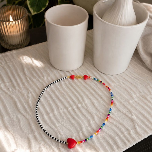 Handmade necklace with colorful beads and red heart