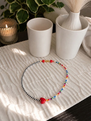 Handmade necklace with colorful beads and red heart
