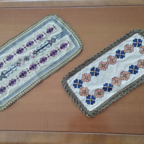Vintage handmade embroidered table linens with cross-stitch and gold thread