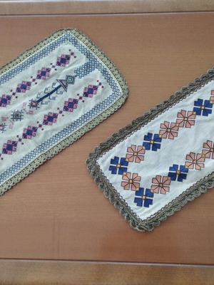 Vintage handmade embroidered table linens with cross-stitch and gold thread