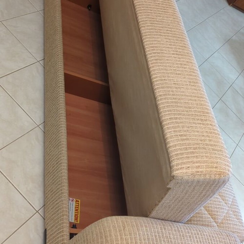 Practical three-seat sofa bed like new with storage compartments