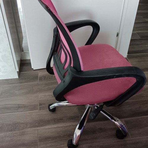 Office chair with armrests used, pink mesh fabric