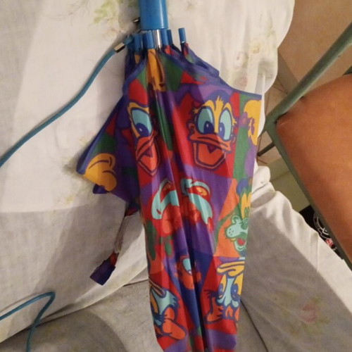 Disney umbrella used with blue Mickey Mouse handle, multicolored