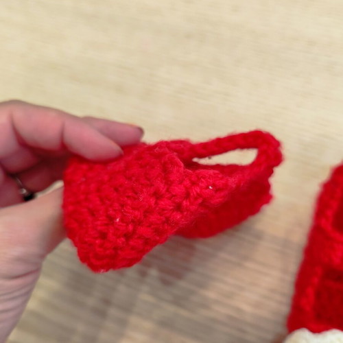 Handmade knitted baby shoes with flower, red