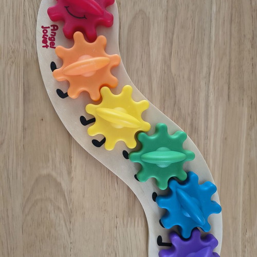 Baby toy with gears like new, wooden base and plastic gears