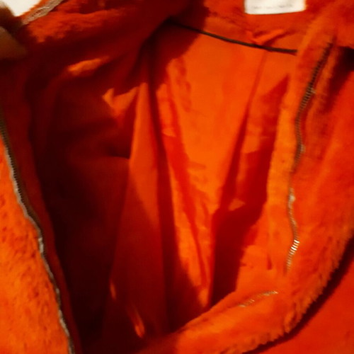 Stradivarius orange fur like new, with torn pocket lining