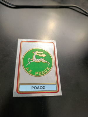 Panini football 82 sticker #328 Rhodes badge