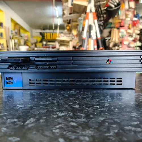 Sony PlayStation 2 console used with Thrustmaster racing wheel and accessories