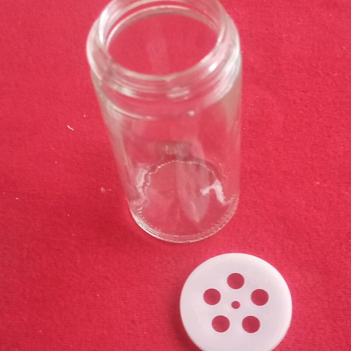 Spice jars used in wooden rotating rack with 16 glass containers