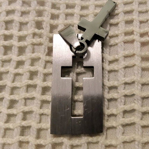 Pendant with steel cross like new, silver color