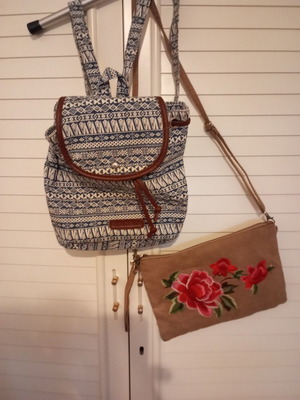Two bags like new, one backpack and one embroidered clutch