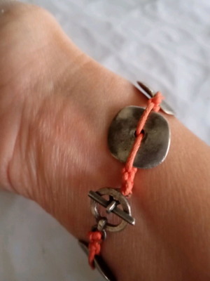 Handmade bracelet with orange cord