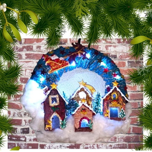 Handmade wreath Santa Claus with sleigh in Christmas village lit with LED