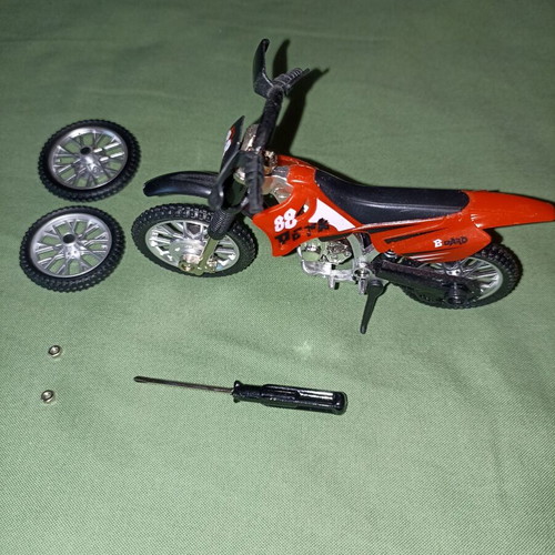 Motocross toy miniature new with extra wheels and nuts