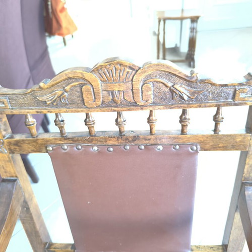 Vintage armchair refurbished with carved wood and leather backrest