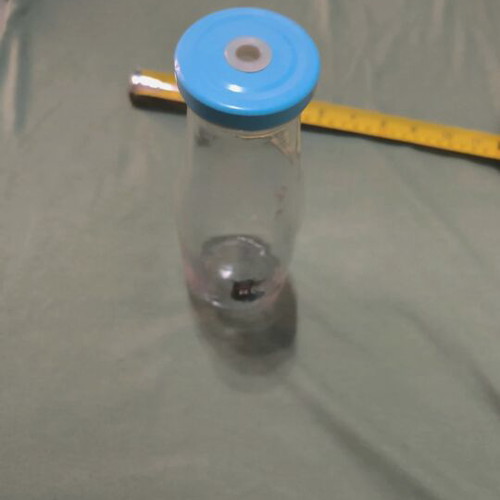 Glass water bottle used with hole for straw