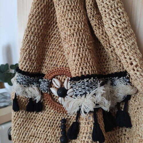 Boho straw backpack used with shells and rope straps, resort style
