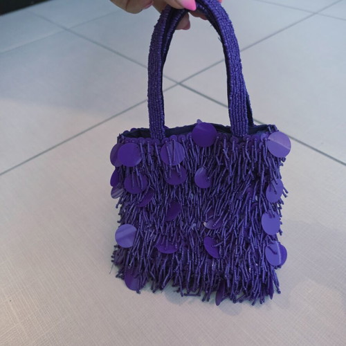 Purple handheld bag with shoulder strap