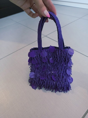 Purple handheld bag with shoulder strap