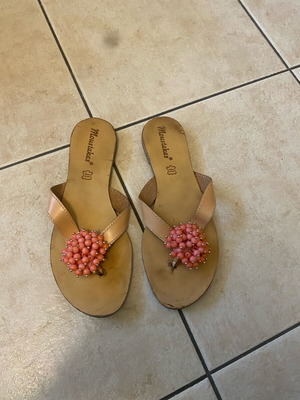 Leather sandals used with orange glass bead flower