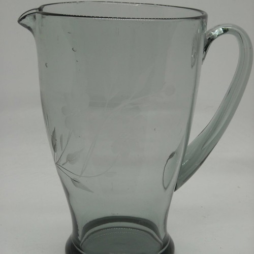 Vintage water pitcher made of blown glass used, gray with floral engravings