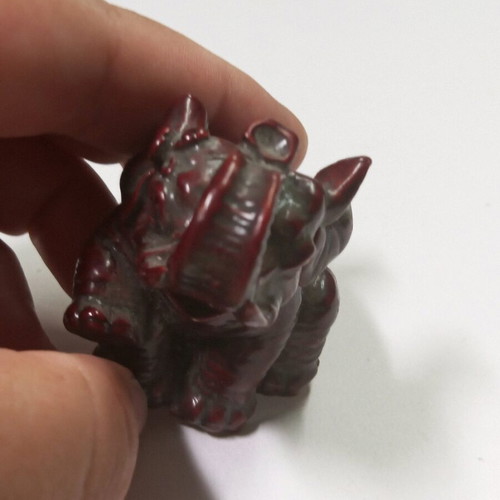 Carved miniature laughing elephant statue like new, burgundy color