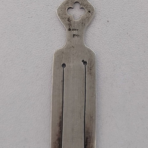 Silver bookmark with cross-shaped handle, used