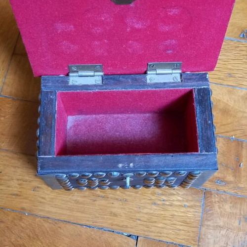 Decorative small wooden chest used with metal details