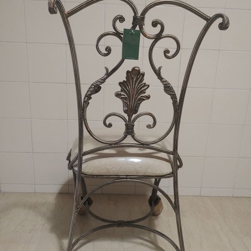 Set of 2 wrought iron dining chairs with decorative leaf details
