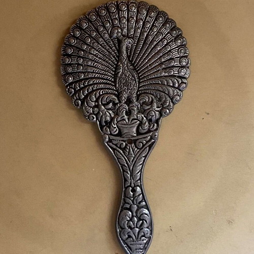 Handheld toilet mirror used with embossed peacock design