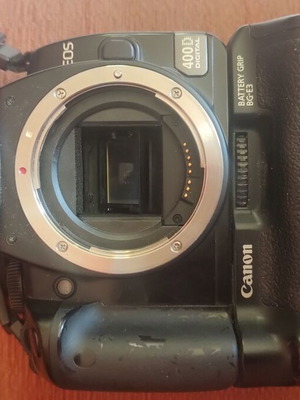 Canon EOS 400D camera used with grip, charger, and two batteries