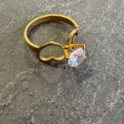 Gold-colored ring used with heart design and zircon stone
