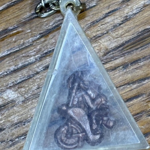 Triangle-shaped keychain used, transparent plastic with metal decoration