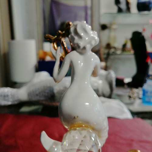 Mermaid and clam used, gold and porcelain decoration