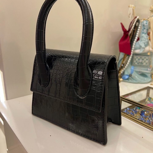 Small black handbag used with strap inside