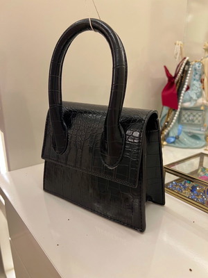 Small black handbag used with strap inside