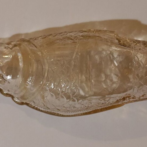 Glass bottle in fish shape used