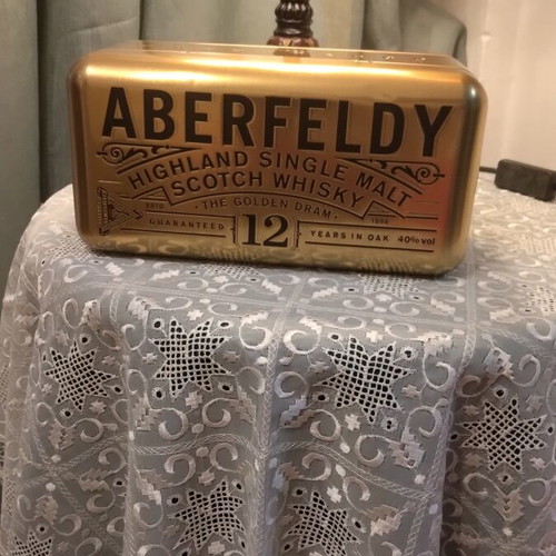 Bottle holder with collectible bottle like new, metal gold color