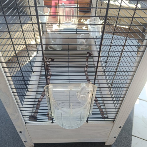 Wooden birdcage used with steel bars and plastic door