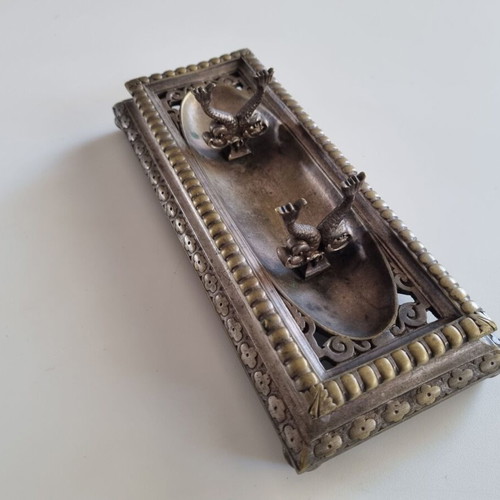 Vintage metal pen tray used with embossed floral motifs and dolphin supports