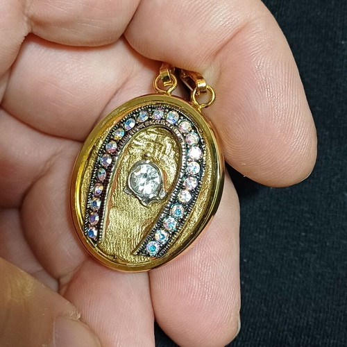 Pendant like new gold-tone horseshoe with zircon crystal