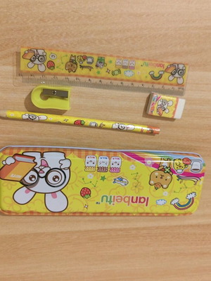 Metal pencil case with school supplies used